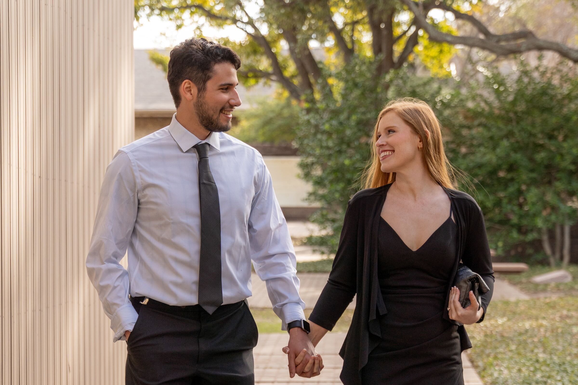 Couple walking hand in hand, sharing a look