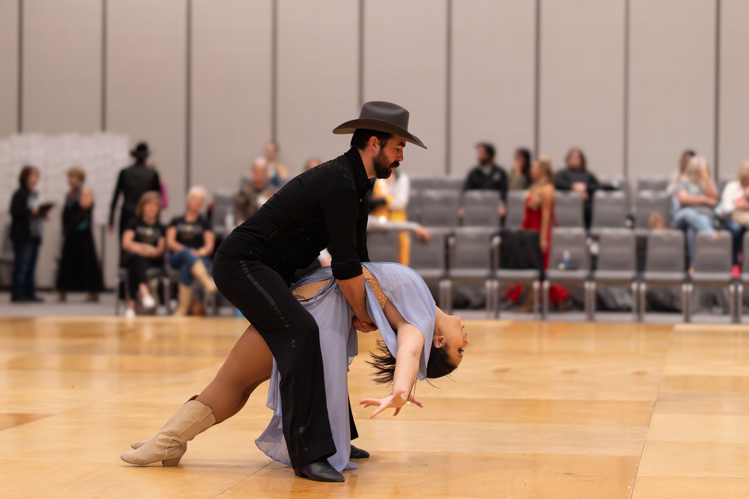 Dancers at the peak of a dip on a ballroom floor